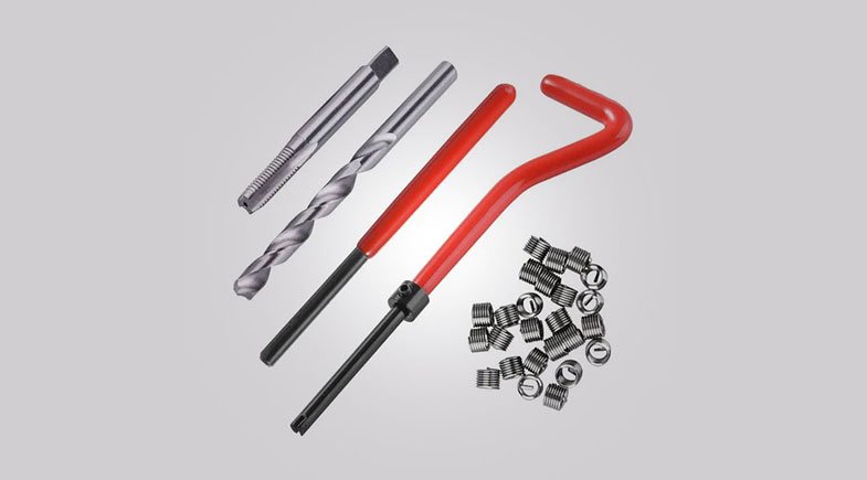 Image of a comprehensive thread repair kit showing thread inserts and tools in a case